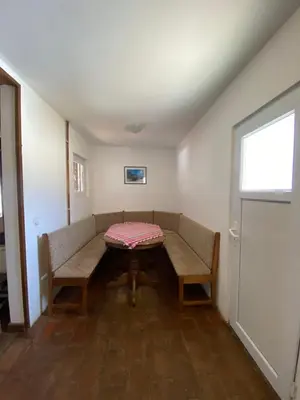 a room with a couch and a table and a window at Kuca za odmor ,,Balkan” in Crni Vrh