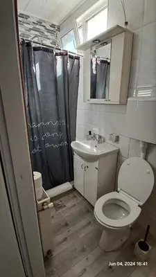a small bathroom with a toilet and a sink at Apartman Iva in Zaječar