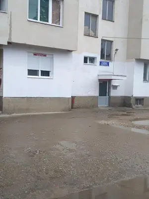 an empty parking lot in front of a building at Apartman Iva in Zaječar