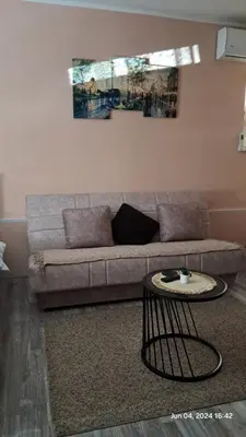 a living room with a couch and a table at Apartman Iva in Zaječar