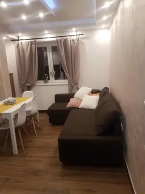 a living room with a couch and a table at Apartman Tea in Kopaonik