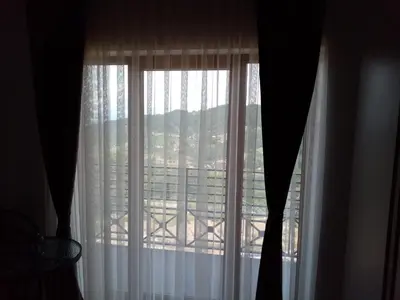 a window with a view of a building at Pčelica L15 Milmari in Kopaonik