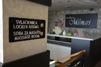 a kitchen with a stove and a sign on the wall at Pčelica L15 Milmari in Kopaonik