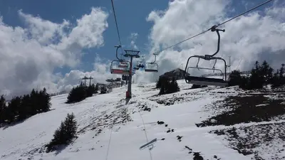 a ski lift going up a snow covered mountain at Pčelica L15 Milmari in Kopaonik