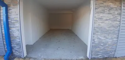 an empty room with a door leading into a garage at Cvetkovic LUX Аpartmani & Free GARAŽA in Vrnjačka Banja