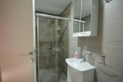 a bathroom with a shower and a toilet and a sink at Cvetkovic LUX Аpartmani & Free GARAŽA in Vrnjačka Banja
