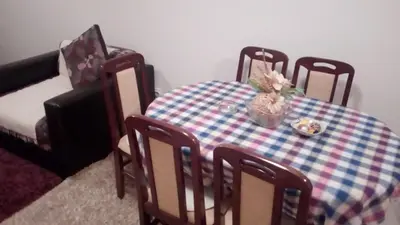 a table and chairs with a plate of flowers on it at FEEL LIKE HOME in Vrnjačka Banja