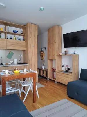 a living room with a table and a couch at Vila Irina - Studio 11 lux in Kopaonik