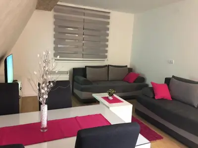 a living room with two couches and a table at Top Kop in Kopaonik