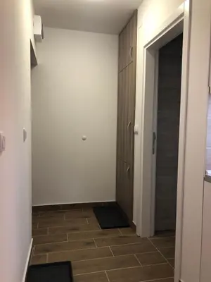 a hallway with a door and a tile floor at Top Kop in Kopaonik