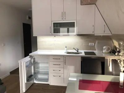 a kitchen with white cabinets and a sink at Top Kop in Kopaonik