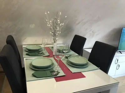 a dining table with plates and wine glasses on it at Top Kop in Kopaonik