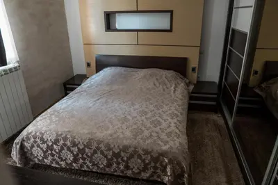 a bed in a small room with a mirror at VILA JEZERO in Kopaonik
