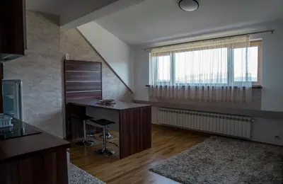 a living room with a desk and a window at VILA JEZERO in Kopaonik