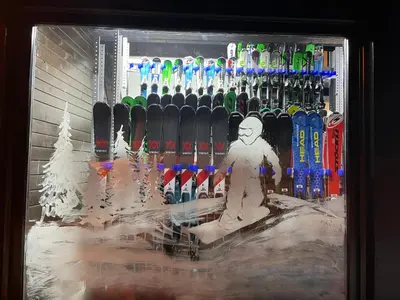 a display case with skis and a snowman on it at VILA JEZERO in Kopaonik