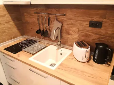 a kitchen counter with a sink and a mixer at Lux Suite S5 Milmari Resort in Kopaonik