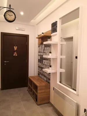 a hallway with a door and a clock on the wall at Lux Suite S5 Milmari Resort in Kopaonik