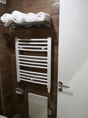 a bathroom with a towel rack next to a toilet at Lux Suite S5 Milmari Resort in Kopaonik