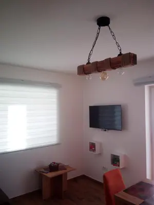 a living room with a television and a table at Iznad oblaka A1 in Kopaonik