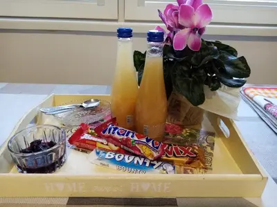 a tray with two bottles of drinks and snacks at Vila I in Niška Banja