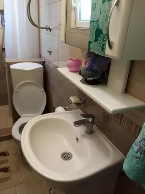 a bathroom with a sink and a toilet at Vila I in Niška Banja