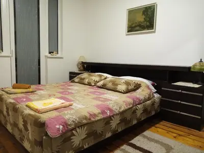 a bedroom with a bed and a dresser at Vila I in Niška Banja