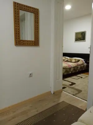 a room with a mirror on the wall and a bed at Vila I in Niška Banja