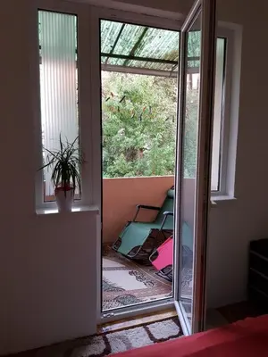 a room with a sliding glass door to a balcony at Vila I in Niška Banja