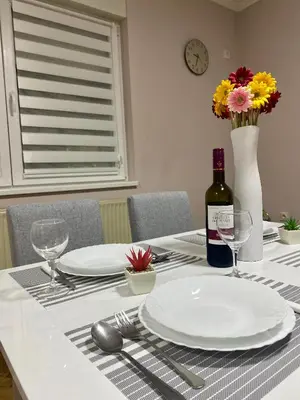 a table with a white plate and a bottle of wine at Apartment 