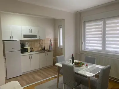 a kitchen and dining room with a table and chairs at Apartment 