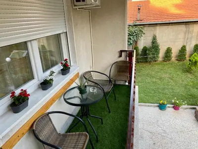 a balcony with three chairs and a table on a porch at Apartment 