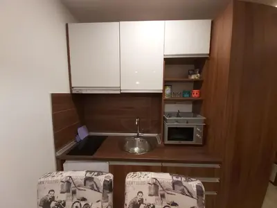 a small kitchen with a sink and a microwave at AMI apartman Kopaonik in Kopaonik