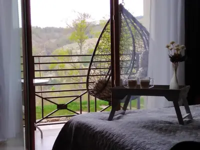 a bedroom with a bed and a view of a window at Apartment Deluxe Sunny Valley Milmari S8 in Kopaonik