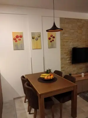 a dining room table with a plate of fruit on it at Apartment Deluxe Sunny Valley Milmari S8 in Kopaonik
