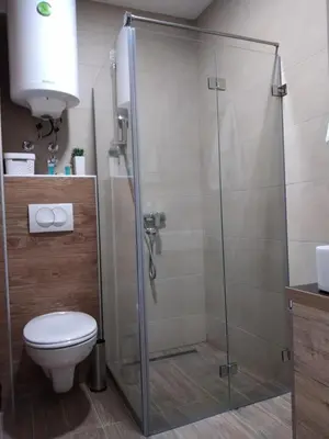 a shower stall in a bathroom with a toilet at Apartment Deluxe Sunny Valley Milmari S8 in Kopaonik