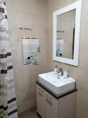 a bathroom with a sink and a mirror at Milmari P39 Kopaonik in Kopaonik
