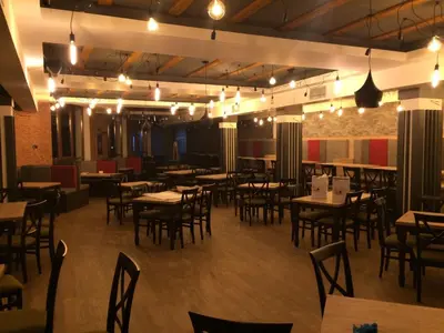 a dining room with tables and chairs and lights at Milmari P39 Kopaonik in Kopaonik