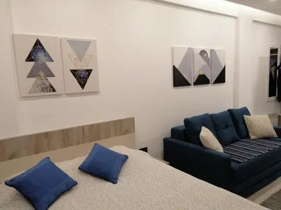 a living room with a couch and a bed at Milmari P39 Kopaonik in Kopaonik