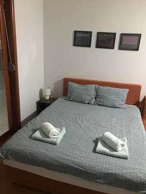a bedroom with a bed with two towels on it at Studio Mišel in Vrnjačka Banja