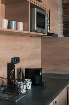 a kitchen with a counter top with a microwave at Silver Kop apartmani in Kopaonik