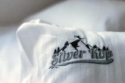 a white shirt with a silver hog logo on it at Silver Kop apartmani in Kopaonik