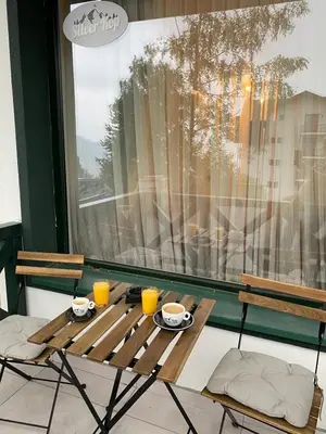 a wooden table with two cups of coffee on it at Silver Kop apartmani in Kopaonik