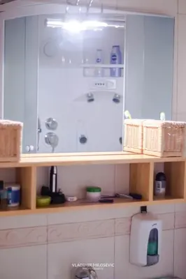 a bathroom with a sink and a shower at Dusko dugousko in Niš
