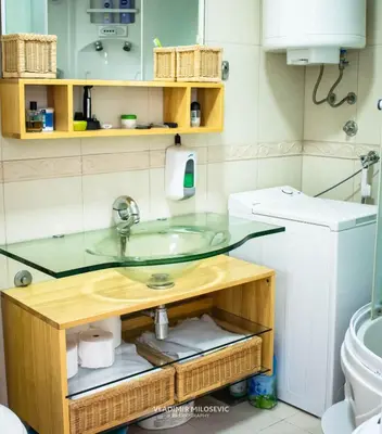a bathroom with a glass sink and a toilet at Dusko dugousko in Niš