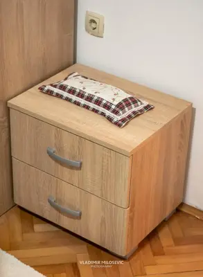 a wooden bed with a pillow on top of it at Dusko dugousko in Niš
