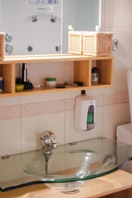 a bathroom sink with a faucet on a counter at Dusko dugousko in Niš