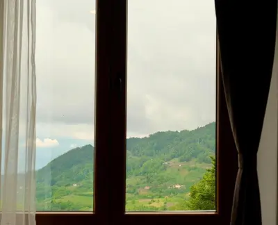 a window with a view of a mountain at Apartman D&V Milmari Resort S10 in Kopaonik