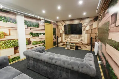 a living room with a couch and a flat screen tv at Harmonija Resort - Harmonija Kopaonik in Kopaonik
