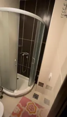 a shower with a glass door in a bathroom at Kopaonik apartmani u Kraljevim Čardacima , Čar 27 i 6-13 in Kopaonik
