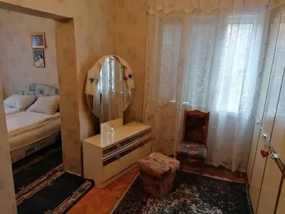 a bedroom with a mirror and a bed and a dresser at Kuca za odmor RADMILA - Rogljevacke pivnice in Rogljevo